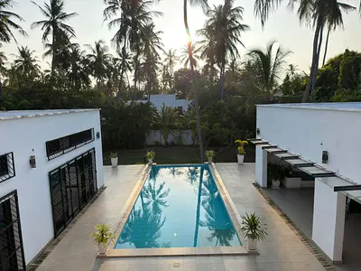 Long swimming pool between the wings of the Mida Creek villa