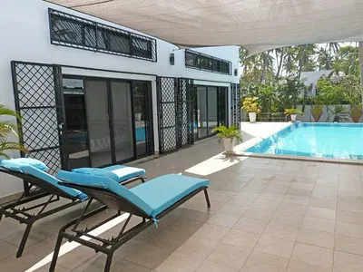 Sun loungers beside the pool at the Mida Creek villa